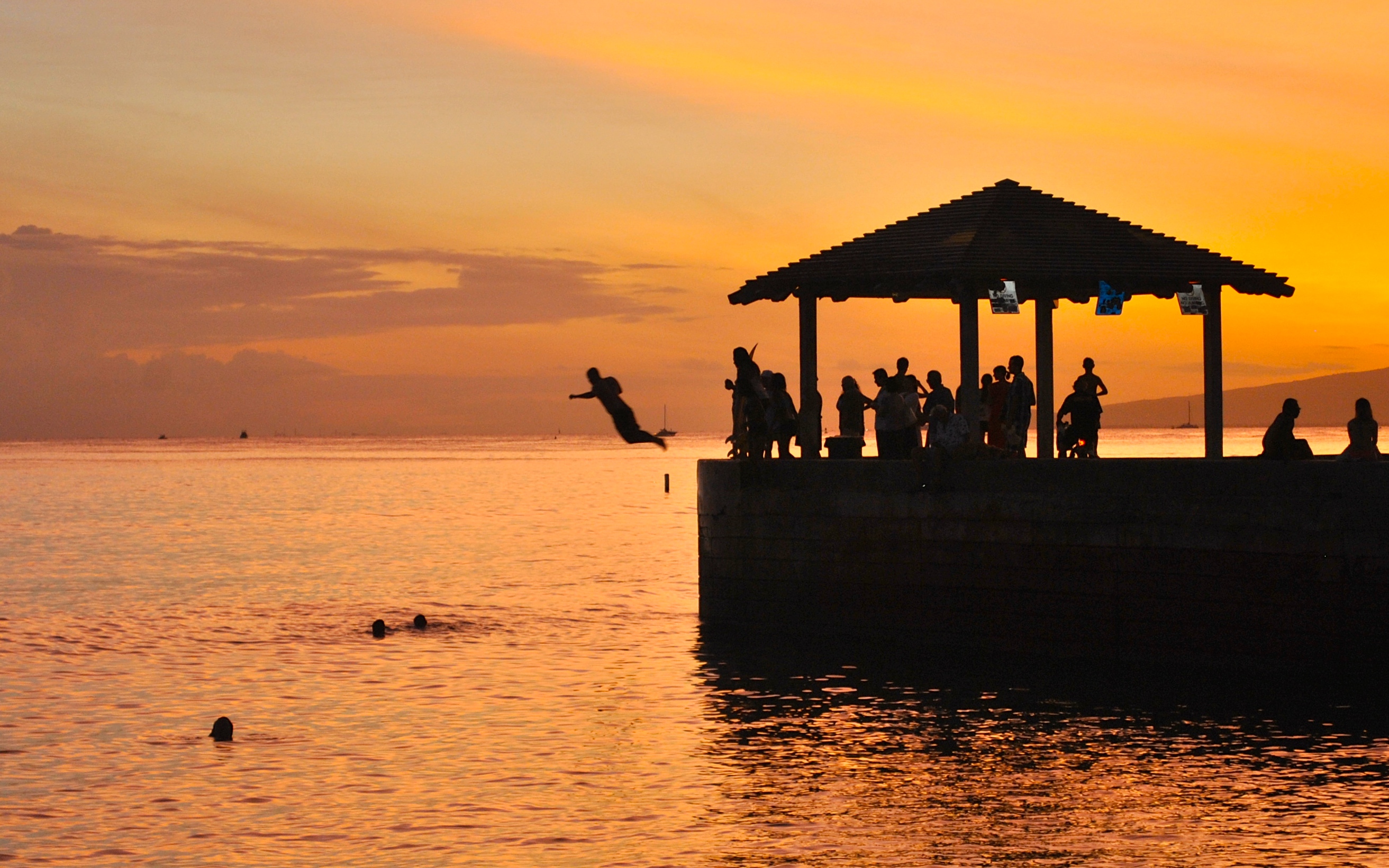 Boy jumping into water